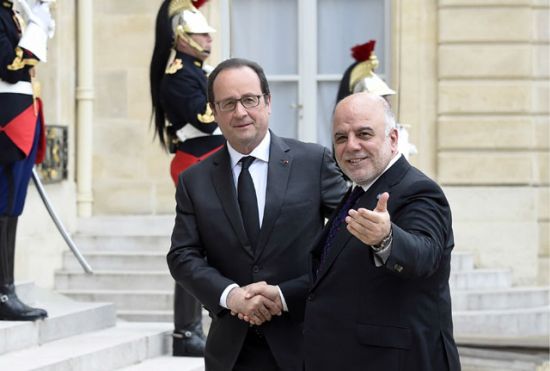 الرئيس الفرنسي فرانسوا هولاند مستقبلاً رئيس الوزراء العراقي حيدر العبادي لدى وصوله قصر الإليزيه - AFP 