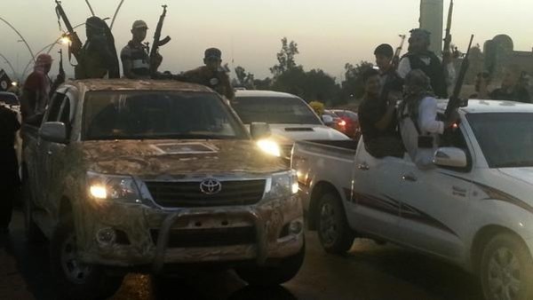 Fighters of the Islamic State of Iraq and the Levant (ISIL) celebrate while sitting on vehicles in the city of Mosul, June 23, 2014. U.S. Secretary of State John Kerry held crisis talks with leaders of Iraq's autonomous Kurdish region on Tuesday urging them to stand with Baghdad in the face of a Sunni insurgent onslaught that threatens to dismember the country. Picture taken June 23, 2014. REUTERS/Stringer (IRAQ - Tags: CIVIL UNREST POLITICS TPX IMAGES OF THE DAY) - RTR3VIAR