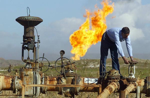 A worker turns a valve at the Shirawa oilfield, where oil was first pumped in Iraq in 1927, outside the northern city of Kirkuk 19 January 2004. The security of northern Iraq's oil infrastructure is improving but exports through the region's main pipeline are yet to resume following months of sabotage and general instability, officials said. In December, Iraq exported nearly 1.7 million bpd "through terminals in the south of the country," Iraq's interim Oil Minister Ibrahim Bahr al-Ulum said 19 January, emphasizing the search for new prospects, notably through the rehabilitation of the Kirkuk-Ceyhan pipeline.       AFP PHOTO/Karim SAHIB (Photo credit should read KARIM SAHIB/AFP/Getty Images)