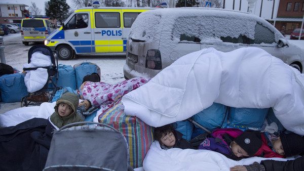 Children Nor, Saleh and Hajaj Fatema from Syria sleep outside the Swedish Migration Board in Marsta, outside Stockholm