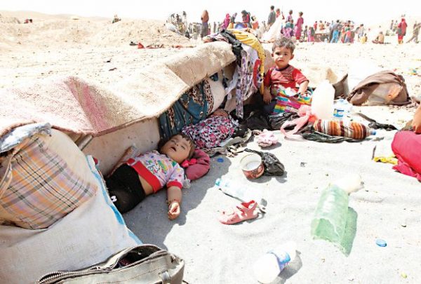 Sunni Muslims who fled the Islamic State's strongholds of Hawija and Shirqat rest after they arrived at the town of Dibis, northwest of Kirkuk