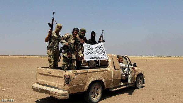 Fighters of the Syrian Islamist rebel group Jabhat Fateh al-Sham cheer after a Russian helicopter was shot down in the north of Syria's rebel-held Idlib province