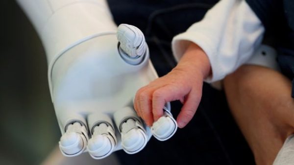 New recruit "Pepper" the robot, a humanoid robot designed to welcome and take care of visitors and patients, holds the hand of a new born baby at AZ Damiaan hospital in Ostend, Belgium June 16, 2016. REUTERS/Francois Lenoir      TPX IMAGES OF THE DAY      - RTX2GKG4
