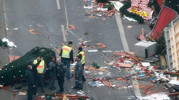 Policemen investigate the scene where a truck ploughed into a crowded Christmas market in the German capital last night in Berlin, Germany, December 20, 2016 REUTERS/Fabrizio Bensch