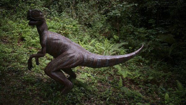 A model of a Velociraptor stands in the forest at the Karpin Abentura park in the Karrantza valley