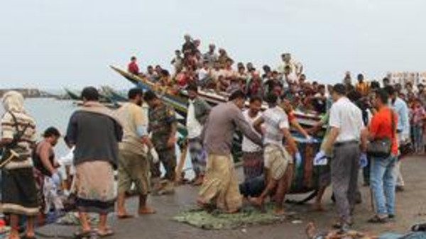Body of a Somali refugee, killed in an attack by a helicopter while travelling in a vessel off Yemen, is carried at the Red Sea port of Hodeidah, Yemen