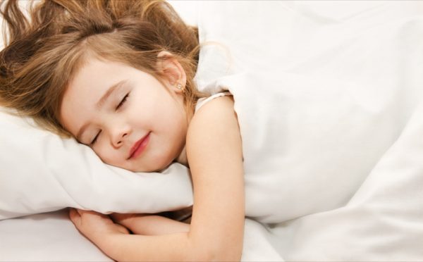 Adorable little girl sleep in the bed