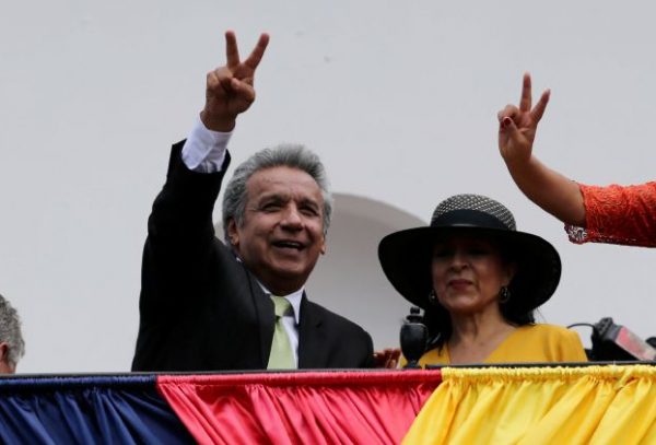 Ecuador's Presidential candidate Lenin Moreno stands next to his wife Rocio Gonzalez as he greets supporters from the government palace's balcony during a military change of guard ceremony in Quito